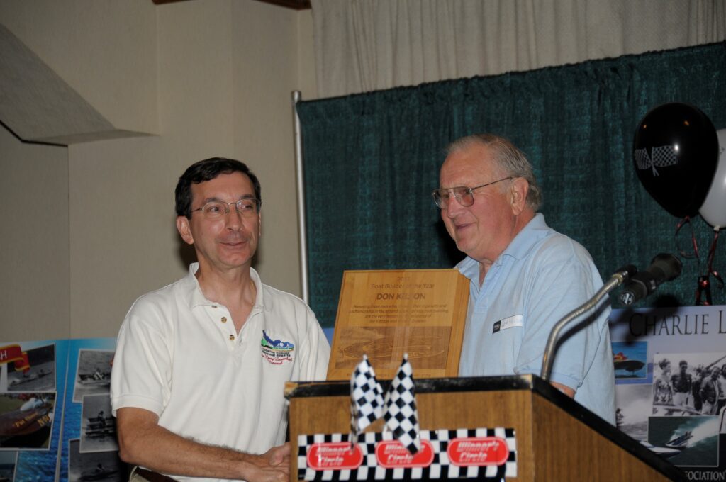 Don Kelson accepting the 2009 Boat Builder of the Year award from event director Daniel Joseph at the 2009 Wheeling Vintage regatta. Photo by Phil Kunz.